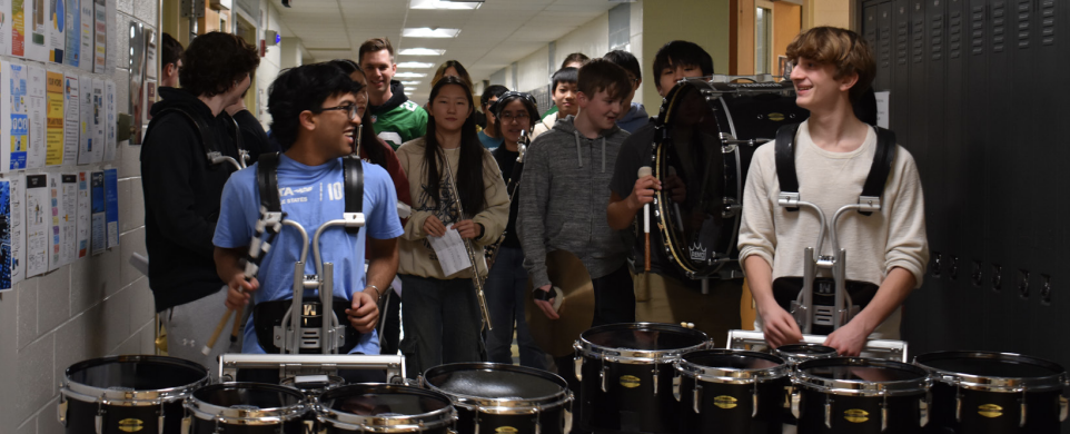 Marching in support: Junior Josh Jacob (left) and sophomore Jack Lutz (right) perform with Wind Ensemble during eighth period on Feb. 7. At the end of the day the Eagles’ fight song played on the announcement system.